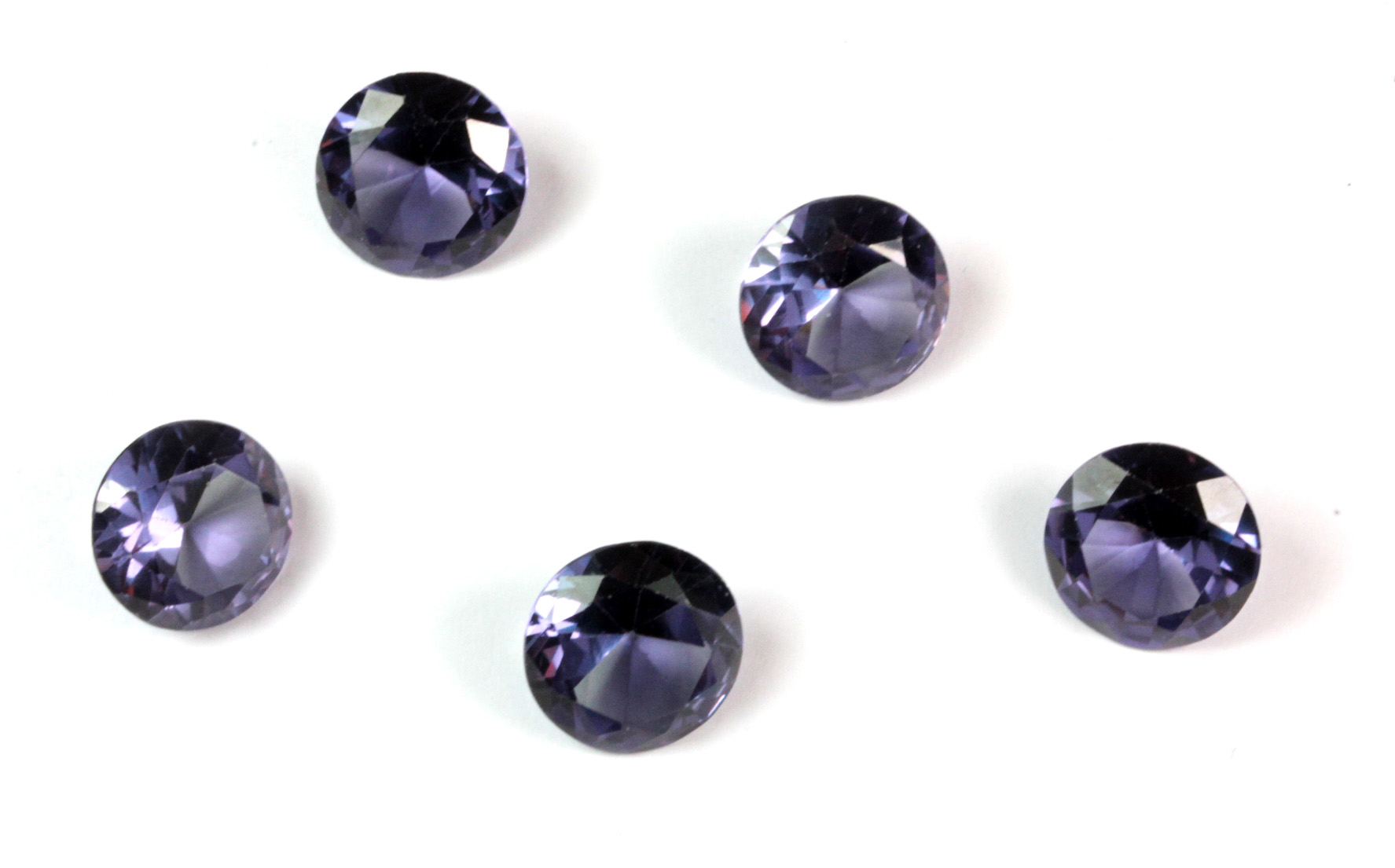 Five unmounted brilliant cut faux alexandrites.