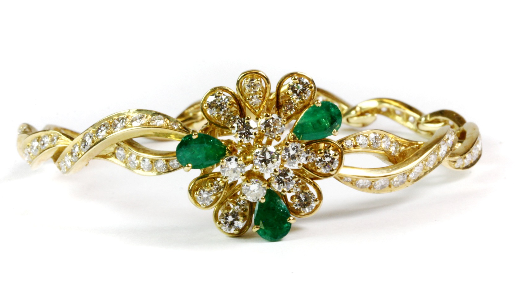 A matching 18ct yellow gold (tested) bracelet set with pear cut emeralds and brilliant cut