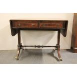 A Regency style mahogany sofa table with brass lion's paw feet, 97 x 60cm.