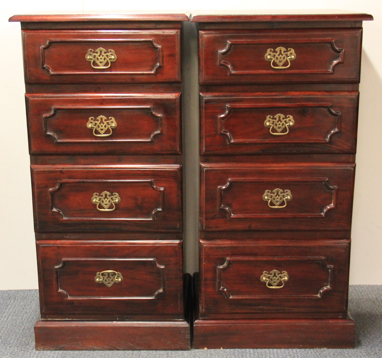 A pair of four drawer contemporary mahogany chest of drawers, H. 102cm, W. 50cm.