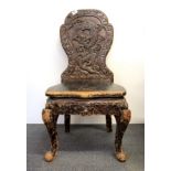 A 19th century Chinese carved softwood and lacquer chair decorated to the back with a dragon.