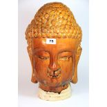 A Chinese glazed pottery model of the Buddha head. H. 41 cms