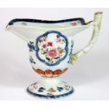 An 18th century Chinese export porcelain sauce boat, H. 13cm, early stapled repair to handle.