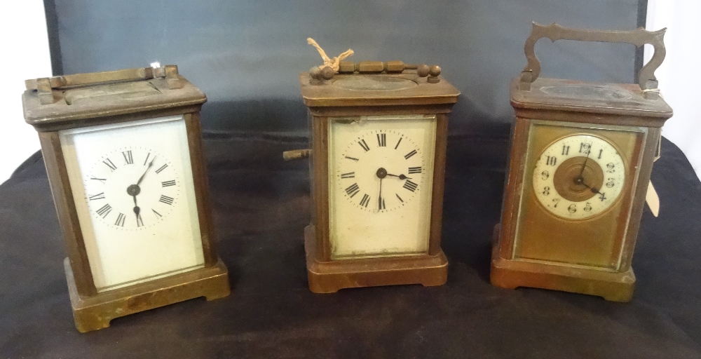 A collection of three brass cased carriage clocks, two having Roman numeral dials,