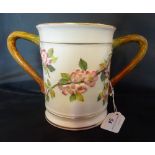 A large Royal Worcester loving cup, having pink blossom decoration in shallow relief,