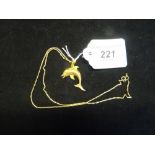 An 18ct gold pendant formed as a dolphin on a 9ct gold fancy link chain. Condition Report: 9g