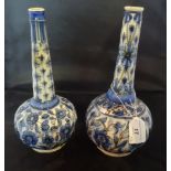 A near matching pair of globular and tapering neck vases,