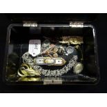 A nephrite jade brooch, a Victorian silver locket, a silver and Carnelian brooch,
