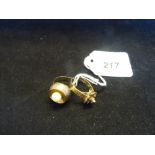 A yellow metal signet ring, marked 333 set with a single pearl,