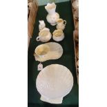 Seven items of Belleek, to include: a side plate formed as a shell, a breakfast cup and saucer set,