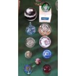 A collection of eleven paperweights, to include: Caithness and Mdina examples, various sizes.