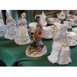 Three ceramic figurines, each of smartly dressed ladies,
