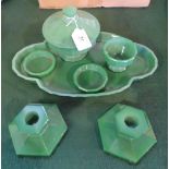 A 1930's Art Deco green glass dressing table set, comprising: twin candlesticks, covered pot,