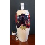 A Walter Moorcroft Anemone pattern tall lamp base, having tubed lined decoration on an ivory ground,