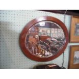 An Edwardian oval oak wall mirror with bevelled plate.