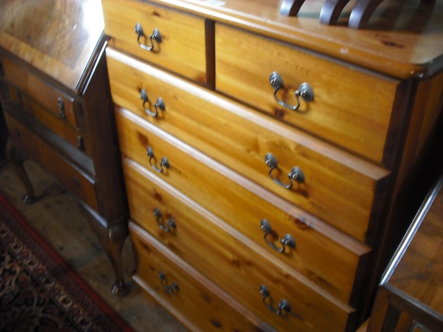 A modern pine chest of two short and four graduated long drawers on bracket plinth.