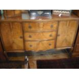 A circa 1930's walnut veneered serpentine fronted sideboard,