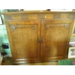 An early 20th century oak cupboard,