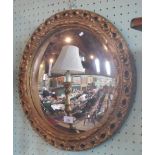 A gilt composite circular wall mirror with convex plate.