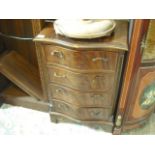 A pair of reproduction mahogany veneered and crossbanded serpentine four drawer chests.