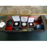 A quantity of silver proof cased coins, including: three Scottish 1986 Commonwealth Games examples,