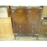 A circa 1930's figured walnut veneered cocktail cabinet,