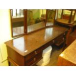 A stag dressing table with triple mirror above an arrangement of five drawers on square tapering