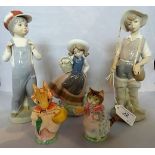 A Lladro figure of a young fisherman, together with two other Lladro figures,