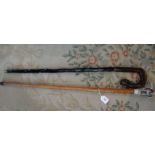 Two walking canes, one with simulated ivory eagle handle,