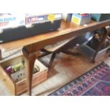 A walnut veneered extending dining table on cabriole legs.