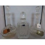 A Royal Worcester decanter and stopper of mallet form, together with two others of onion shape,