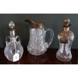 A cut glass crystal water jug, having silver mount,