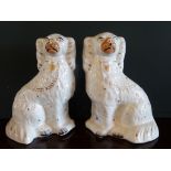 A pair of seated Staffordshire Spaniels of typical form and decoration (24cm).