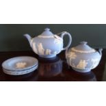 Five items of Wedgwood blue Jasperware, to include: teapot, covered sugar bowl and three pin dishes,