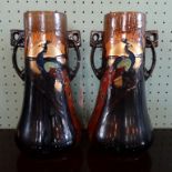 A pair of Thomas Forester Phoenix Ware vases, each with twin handles and peacock decoration,