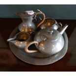 An early 20th century pewter tea set in the Arts & Crafts style, comprising: tray, teapot,