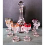 A cut glass spirit decanter and six conforming glasses,