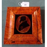 A reverse painted on glass silhouette of William IV (9.5cm x 8cm) in a walnut veneered frame.