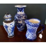 A Doulton Burslem blue and white jug, together with two Chinese blue and white vases.