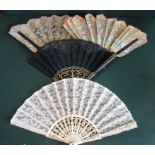 A late 19th century/early 20th century gilt and white painted wooden folding fan,