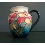 A Walter Moorcroft jug decorated in the African Lily pattern, tube lined,
