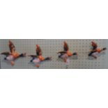 A set of four mid-20th century graduated Beswick flying ducks, printed and impressed marks,