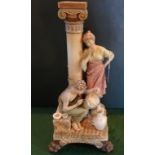 A Royal Dux printed porcelain figure group, modelled as a potter decorating vases,