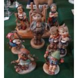 Seven Goebel/Hummel figurines, to include: a pair modelled as bookends, the tallest (15cm).