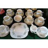 A Coalport part-tea service, a ten place setting comprising: trios, cake plate,