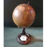 A Philips terrestrial globe on ebonised circular stand, indistinctly labelled (15cm diameter,