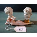 A pair of ceramic busts of a boy and girl, each signed Benacchio,