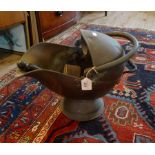 A copper helmet shaped coal scuttle and coal scoop.