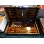An inlaid folding games box, having chess board to the top, backgammon to the interior,