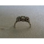 A three stone diamond half-hoop ring, the graduated brilliant cut diamonds in curved claw mounts,